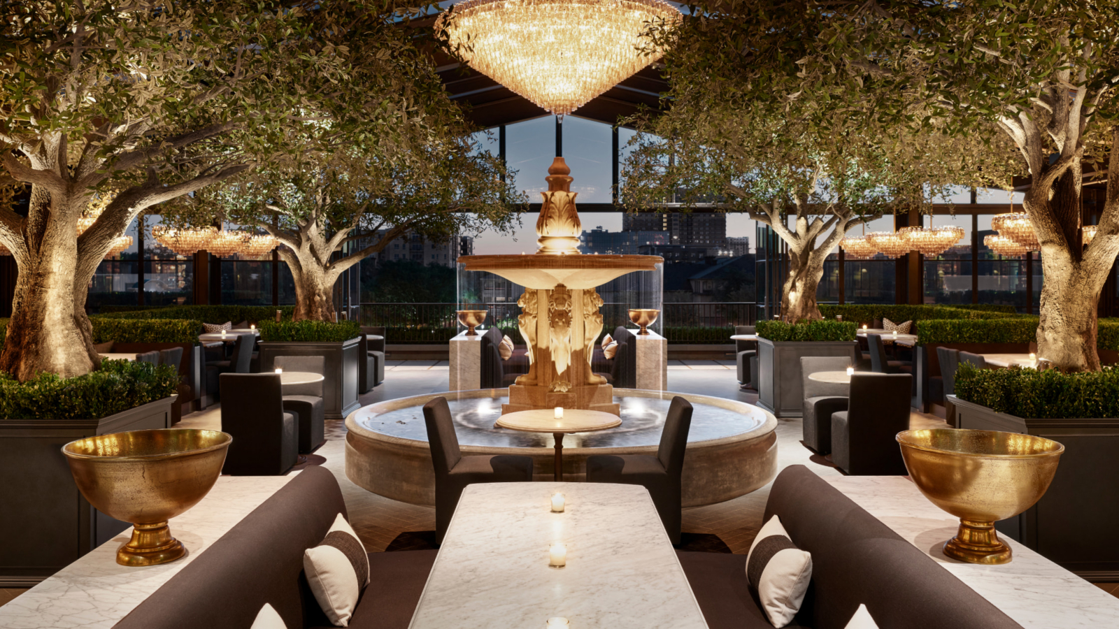 A stunning view of the Rooftop Restaurant at RH Dallas, showcasing elegant dining amidst a vibrant city skyline.