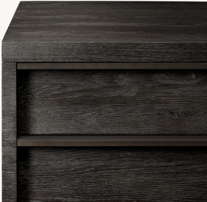 View of the top and drawer fronts of a narrow dresser.