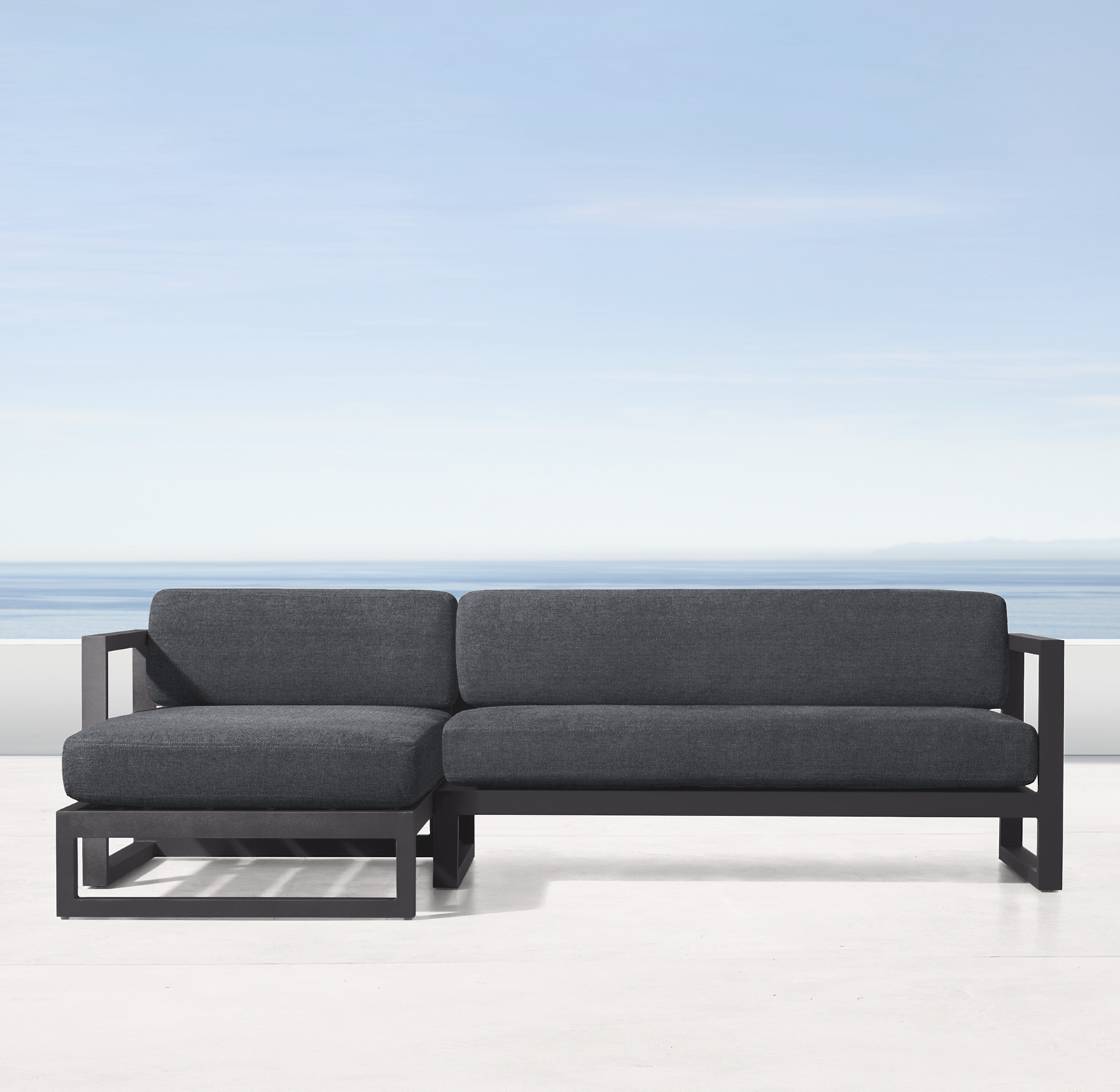 Shown in Slate. Cushions (sold separately) shown in Charcoal Perennials&#174; Performance Canvas. Sectional consists of 1 left-arm chaise and 1 two-seat right-arm sofa.