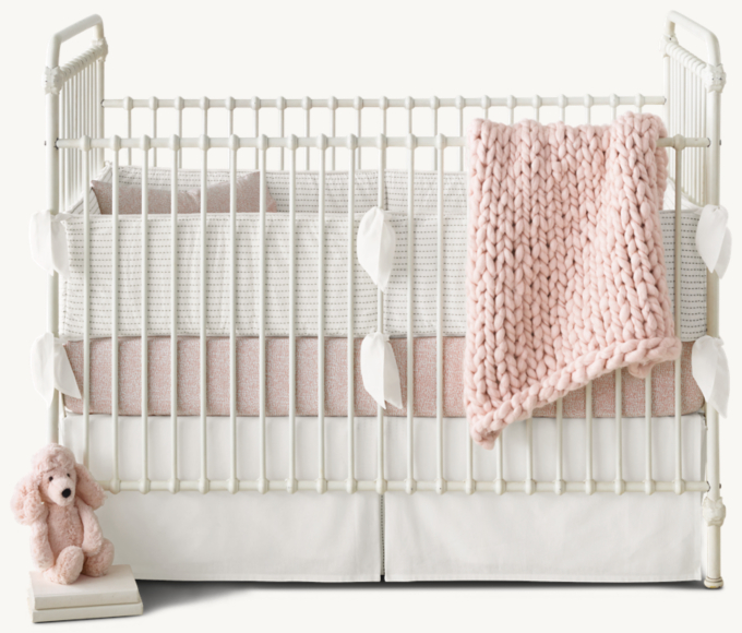 Crib fitted sheet and toddler pillowcase in Dusty Mauve. Crib skirt in Cream.