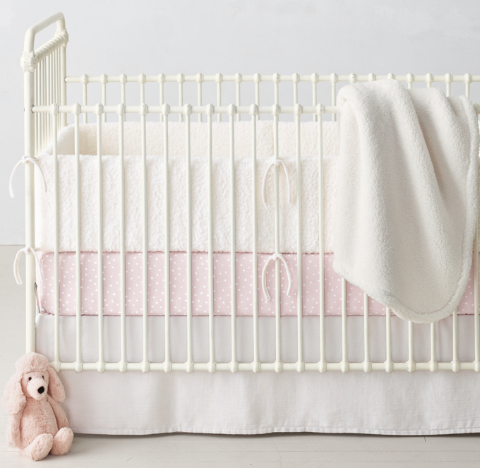 Crib bumper and stroller blanket shown in Ivory. Crib fitted sheet shown in Pink. Crib skirt shown in White. 