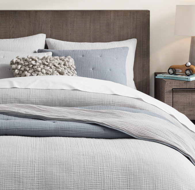 Duvet cover and shams shown in Grey. Sheet set shown in White. Quilt and quilted sham shown in Ocean. Decorative pillow cover shown in Ash.